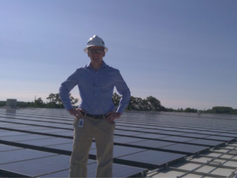 James Bell-Torres troubleshooting a rooftop solar photovoltaic array